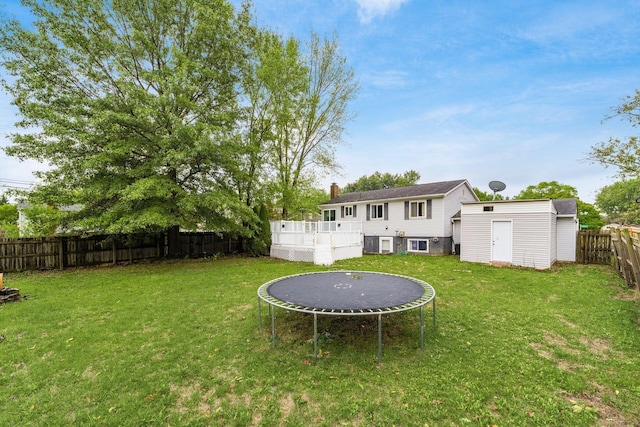 view of yard with an outdoor structure and a trampoline