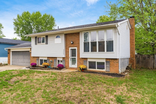 split foyer home with a garage and a front lawn