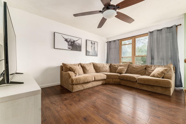 living room with ceiling fan and dark wood-type flooring