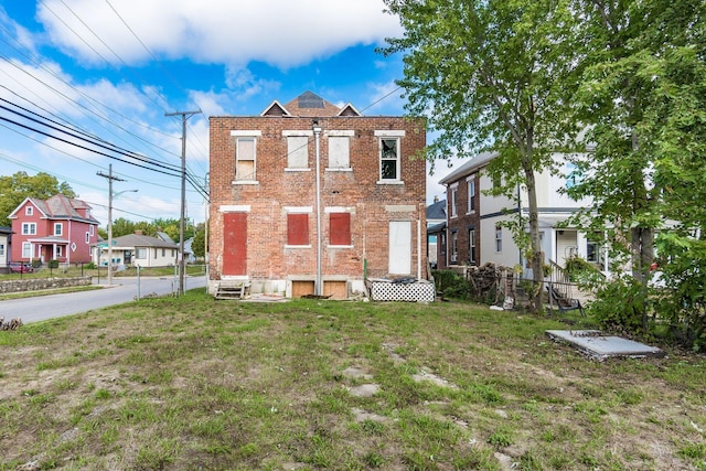 rear view of property with a yard