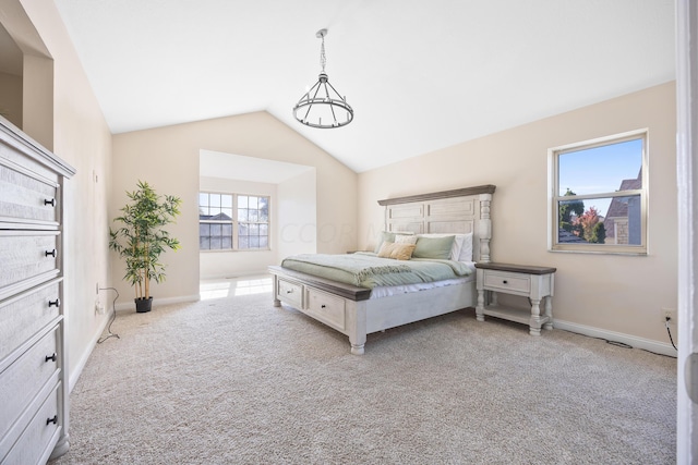 bedroom featuring multiple windows, light carpet, and vaulted ceiling