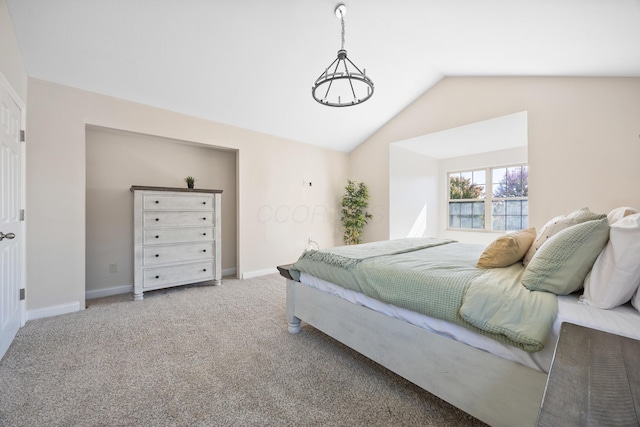 carpeted bedroom with lofted ceiling