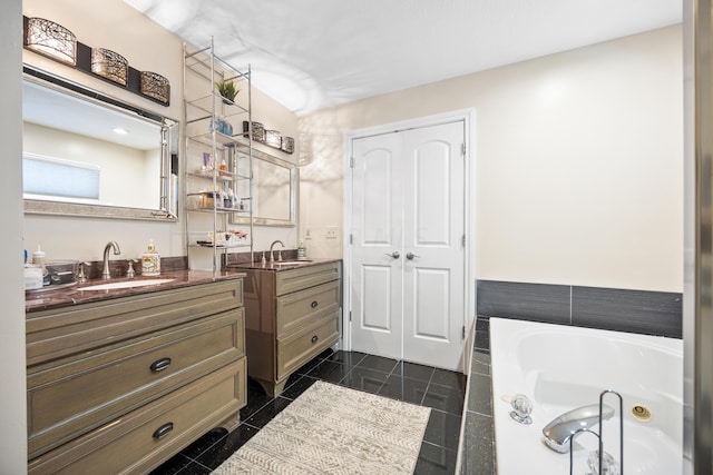 bathroom featuring tile patterned flooring, vanity, and a bathtub