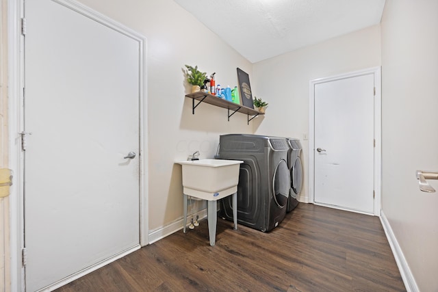 washroom featuring independent washer and dryer, dark hardwood / wood-style flooring, and a textured ceiling