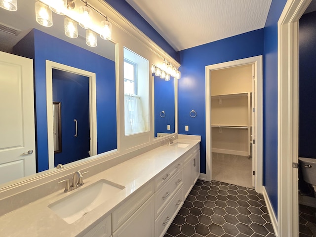 bathroom with a textured ceiling and vanity