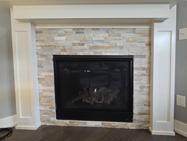 interior details featuring a fireplace and wood-type flooring