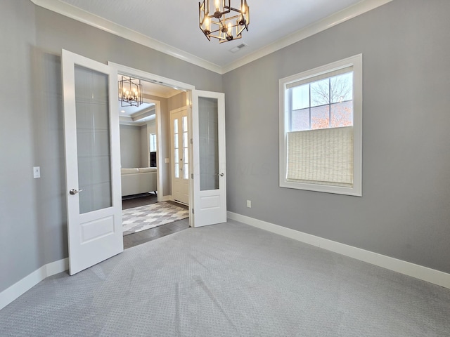 unfurnished bedroom featuring a notable chandelier, french doors, crown molding, and carpet flooring