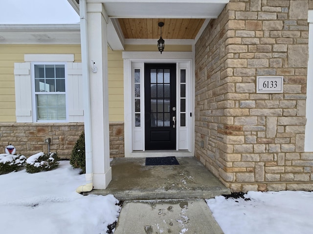 view of snow covered property entrance