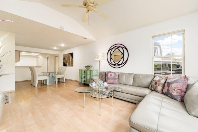 living room with light hardwood / wood-style flooring, ceiling fan, and lofted ceiling