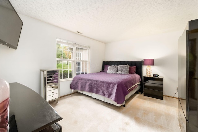 carpeted bedroom featuring a textured ceiling