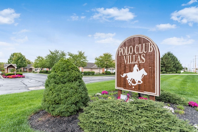 community / neighborhood sign with a lawn