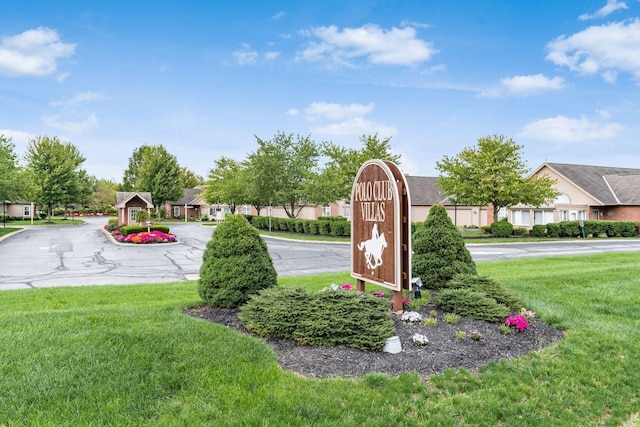 community sign featuring a lawn