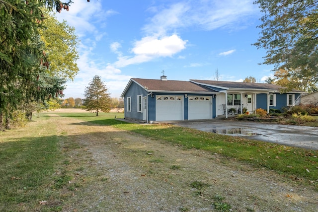 view of front of house with a porch, a garage, and a front yard