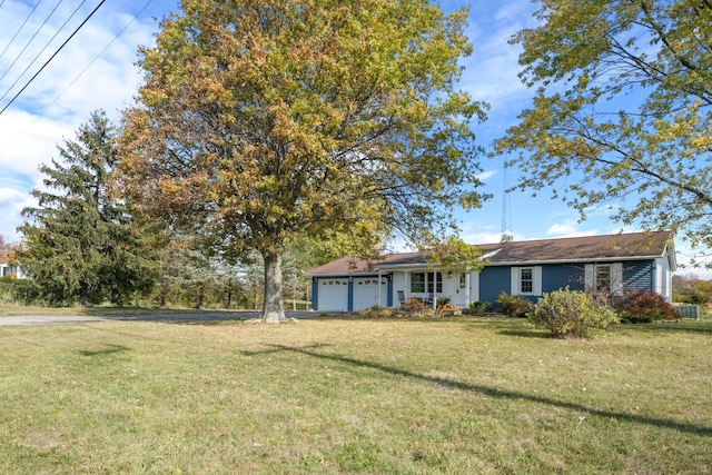 single story home featuring a garage and a front lawn