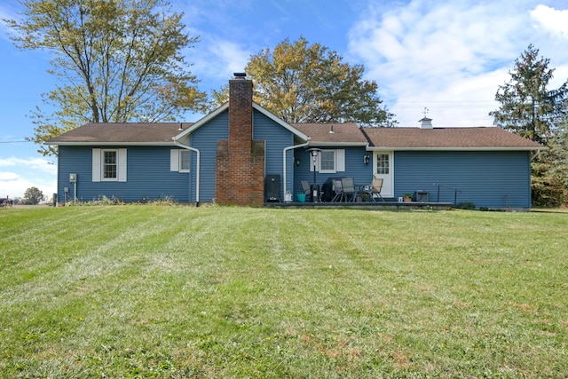 rear view of property featuring a yard