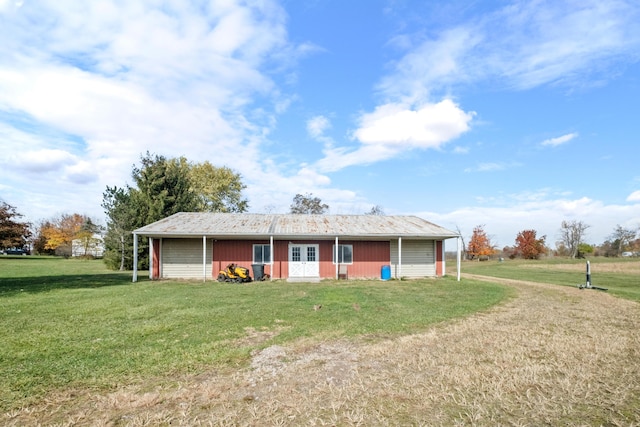 view of front facade with an outbuilding and a front lawn