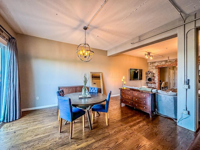 dining space with hardwood / wood-style floors and a notable chandelier