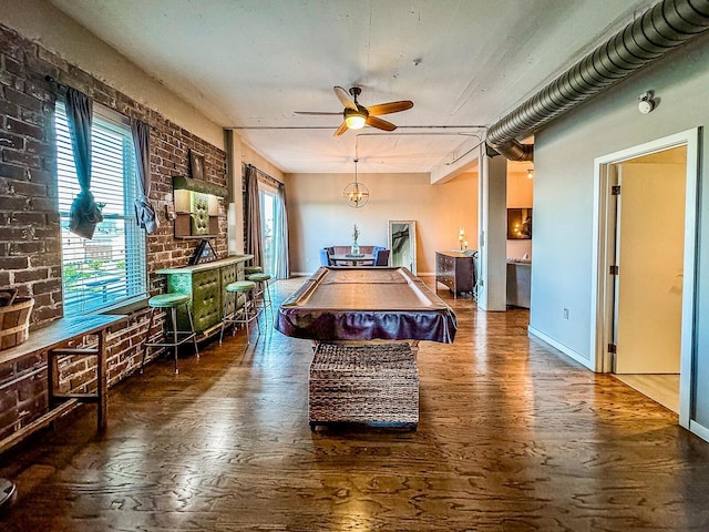 recreation room featuring hardwood / wood-style flooring, ceiling fan, brick wall, and billiards