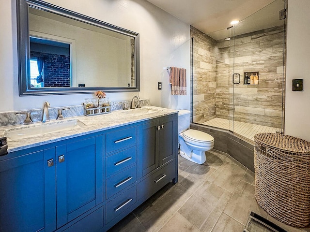 bathroom featuring vanity, toilet, and an enclosed shower