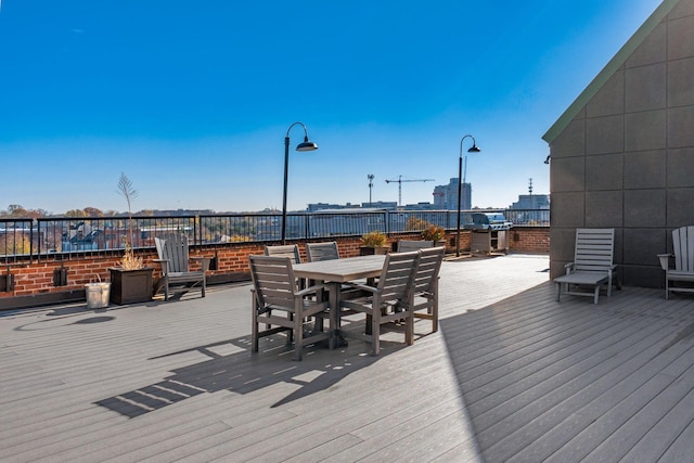 wooden deck featuring a grill and an outdoor fire pit