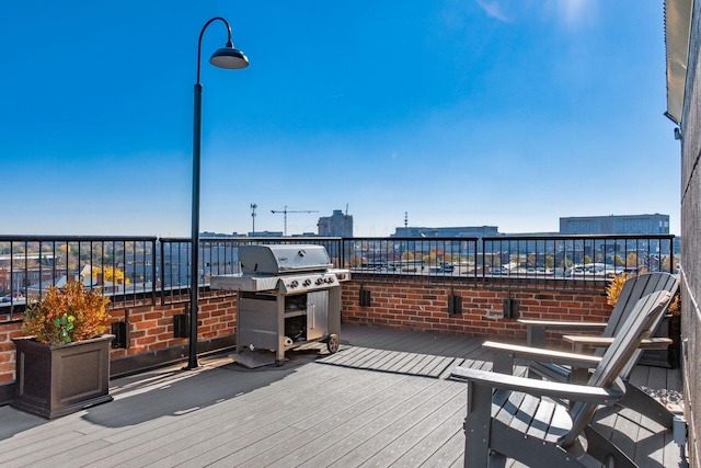 wooden deck with a grill