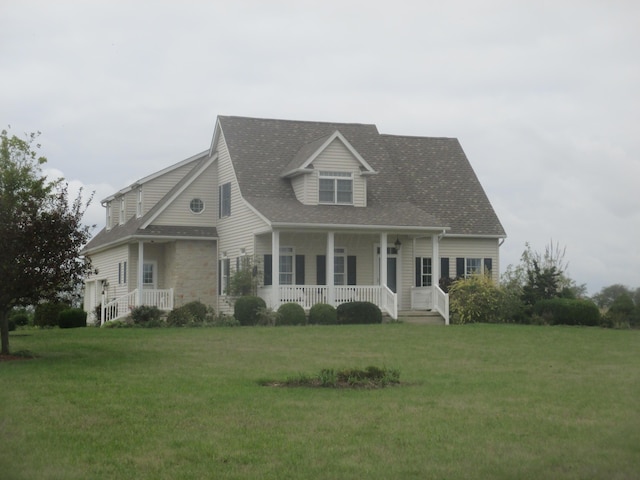 cape cod house featuring covered porch and a front lawn