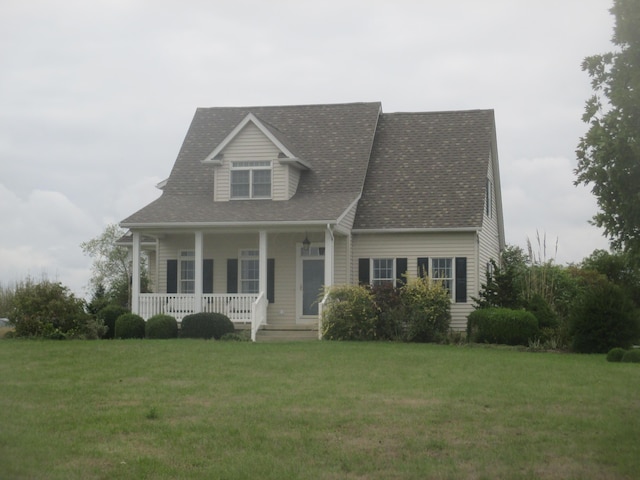 new england style home with a porch and a front lawn