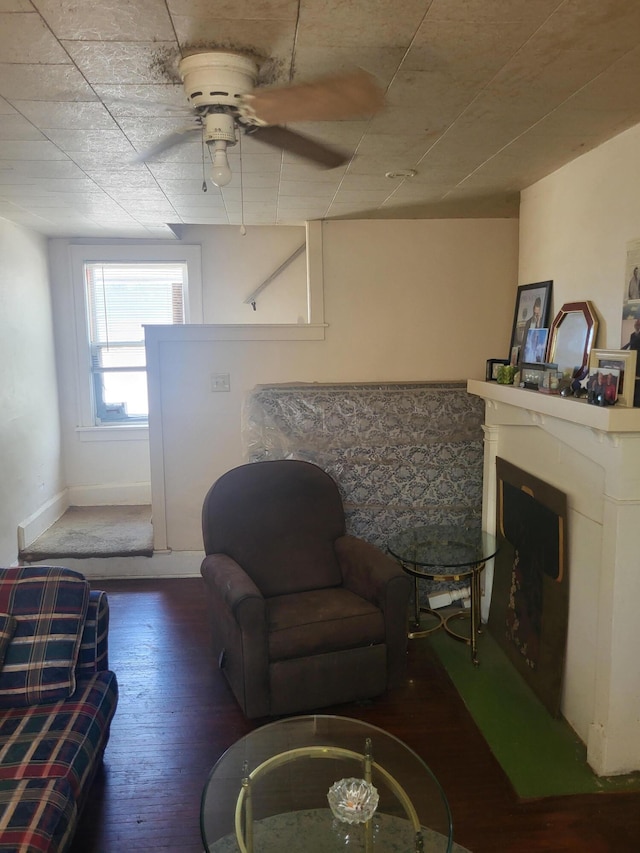 living room with ceiling fan and dark wood-type flooring