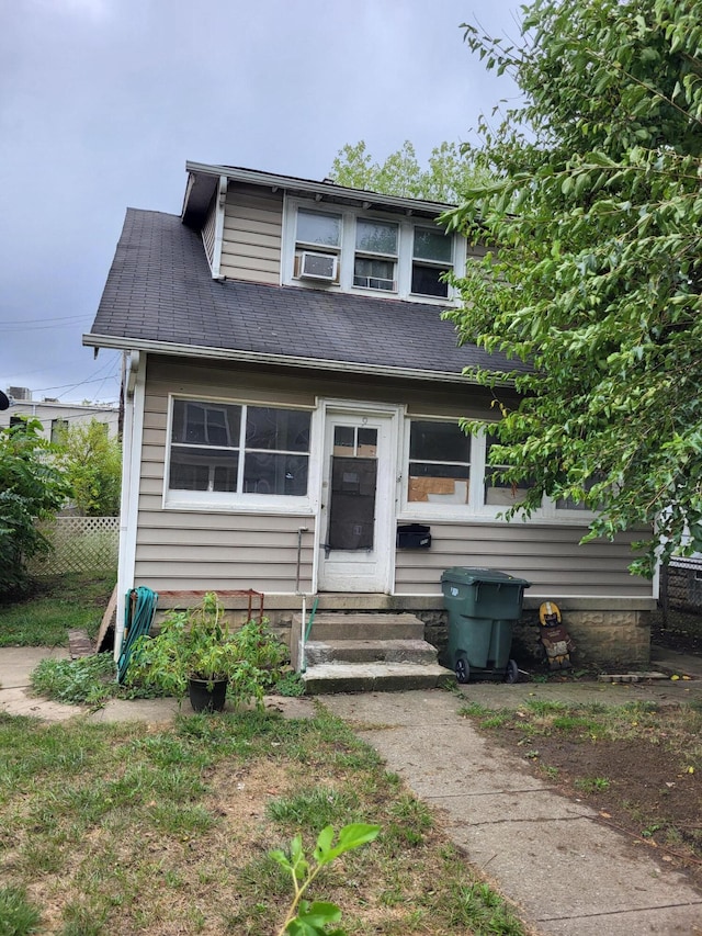 bungalow-style house featuring cooling unit