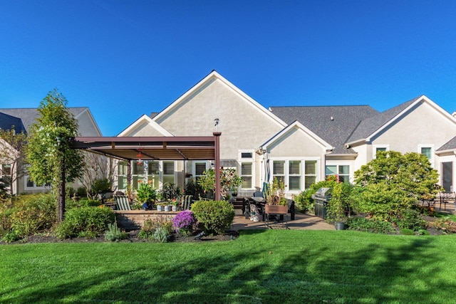 rear view of property with a yard and a patio