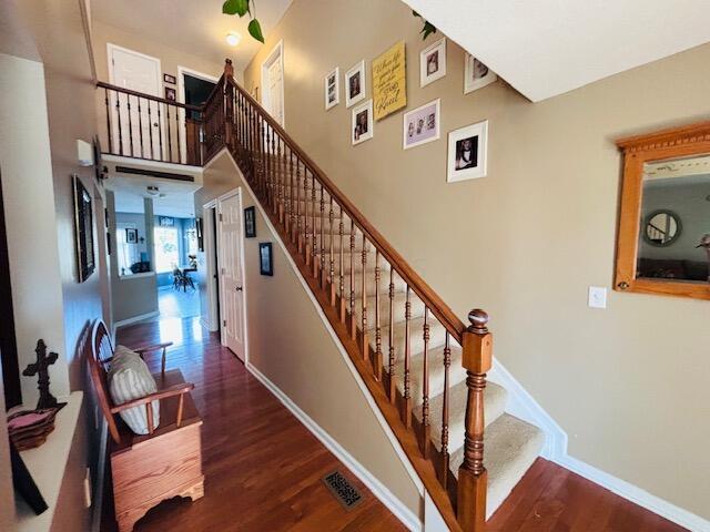 staircase with hardwood / wood-style floors