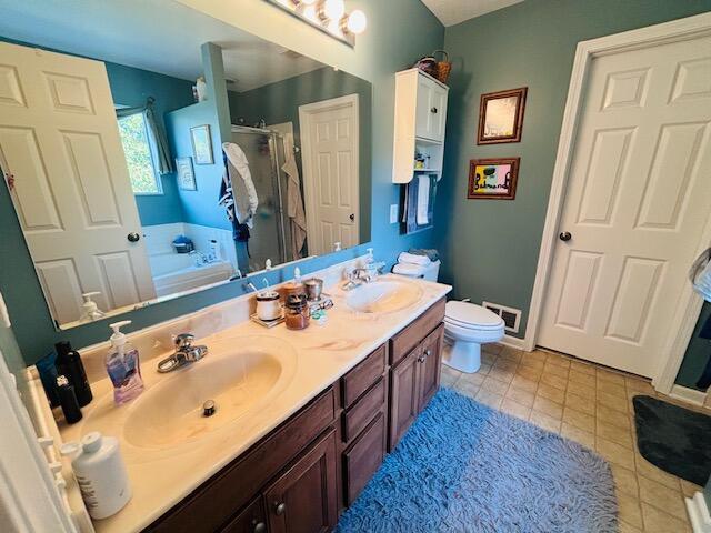 full bathroom featuring separate shower and tub, tile patterned floors, vanity, and toilet