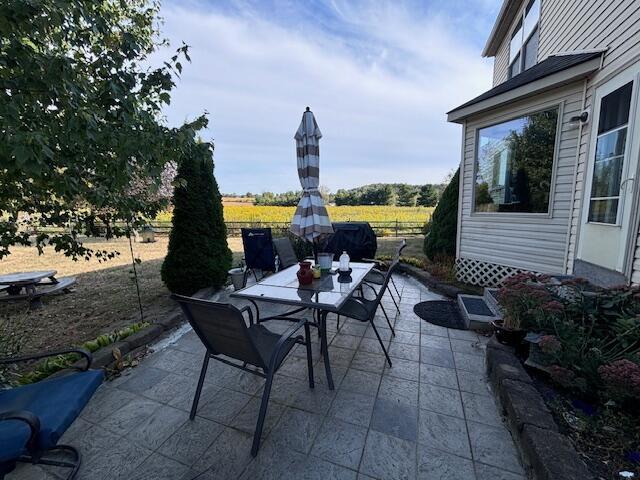 view of patio / terrace with a rural view