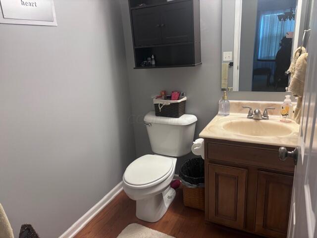 bathroom featuring hardwood / wood-style floors, vanity, and toilet