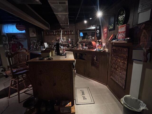 bar featuring dark brown cabinets