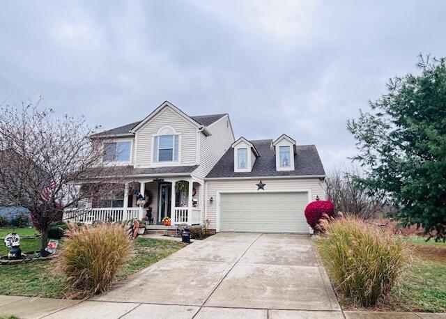 view of front of property featuring covered porch and a garage