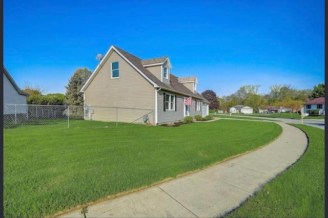 view of side of home with a yard