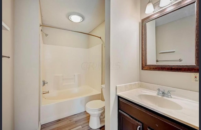 full bathroom featuring washtub / shower combination, toilet, wood-type flooring, and vanity