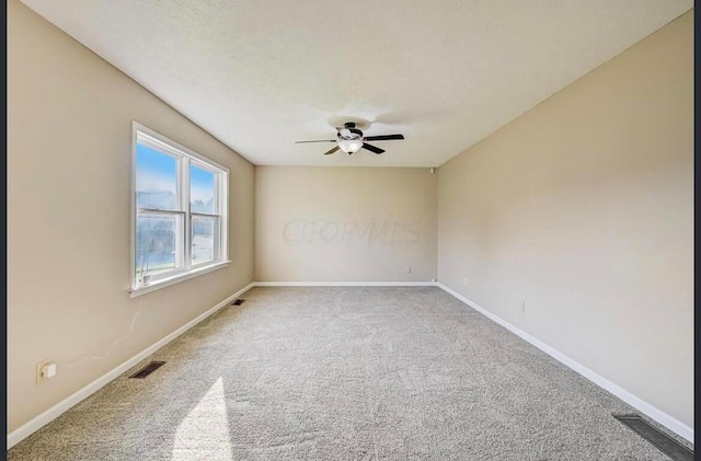 carpeted empty room featuring a textured ceiling and ceiling fan