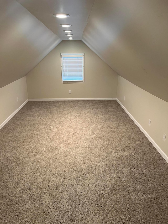bonus room with baseboards, carpet flooring, and lofted ceiling