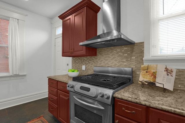 kitchen with gas stove, decorative backsplash, a wealth of natural light, and wall chimney exhaust hood