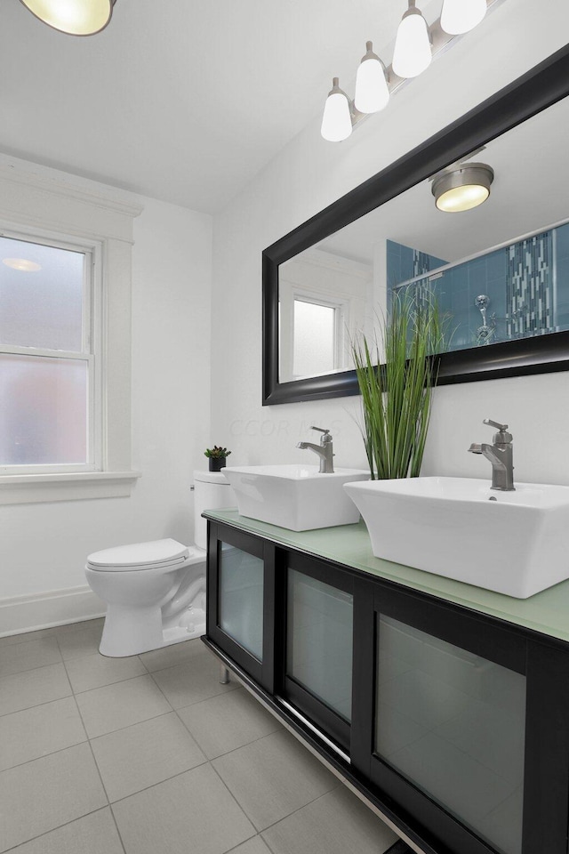 bathroom with tile patterned flooring, vanity, and toilet