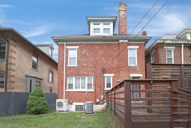 back of property with central air condition unit and ac unit