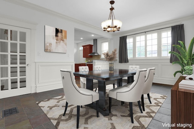 dining area with a chandelier and ornamental molding