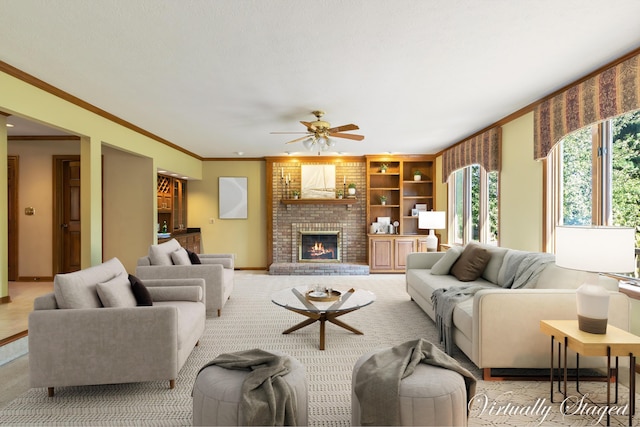 living room featuring crown molding, a fireplace, and ceiling fan