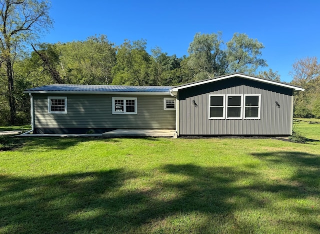 rear view of property with a yard