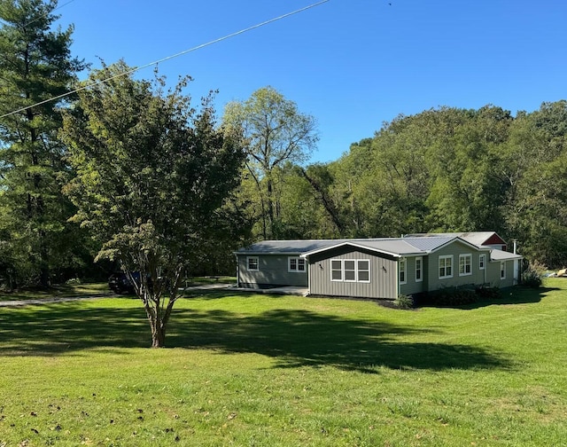 rear view of property with a lawn