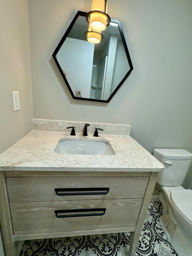 bathroom featuring tile patterned floors, vanity, and toilet