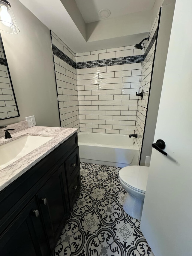 full bathroom featuring vanity, toilet, and tiled shower / bath