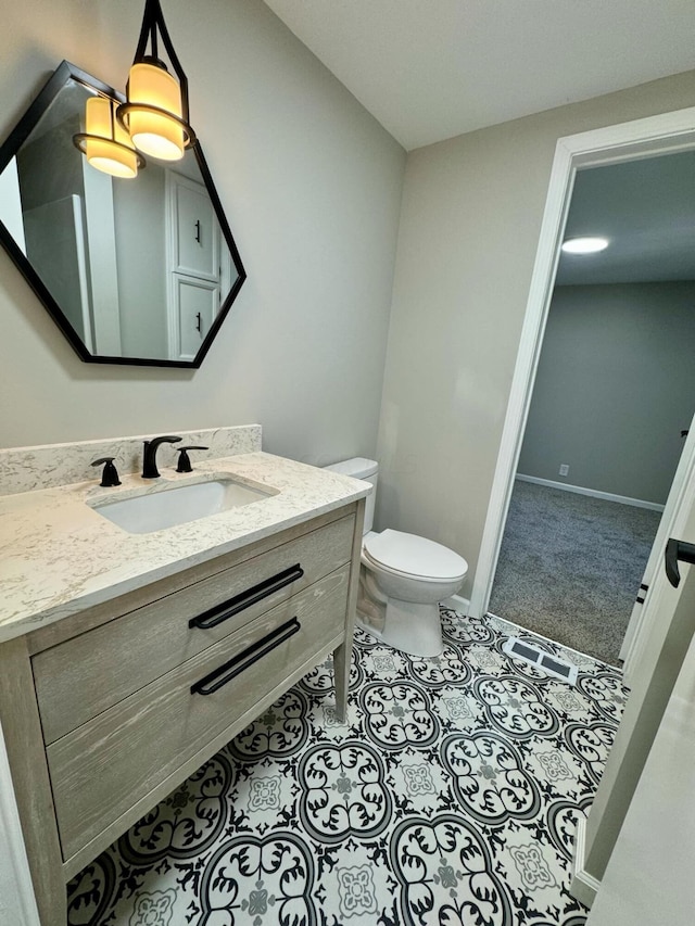 bathroom featuring vanity and toilet